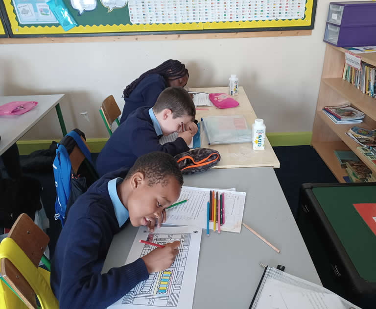 Three Pupils working in classroom at Our Lady Of Mercy Primary School