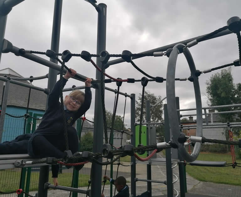 Pupil on bars in playground