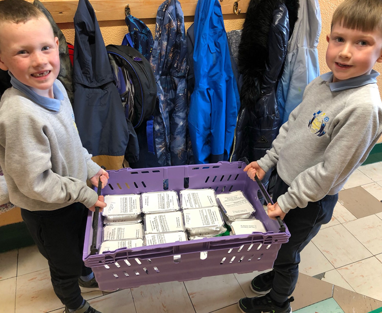 Pupils carrying lunch trays