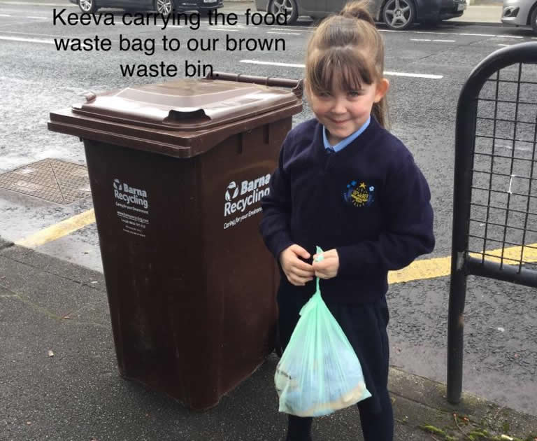 Pupil holding waste bag for recycling bin